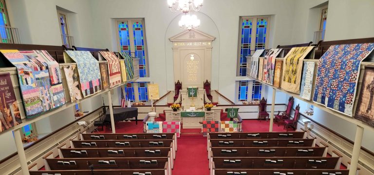 Quilts around church balcony