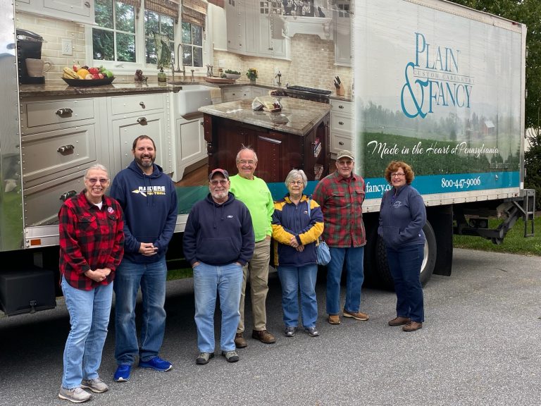 group next to Plain & Fancy truck